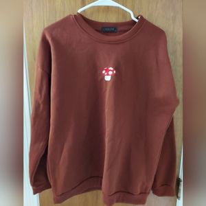 Rust colored sweat shirt with embroidered mushroom 🍄